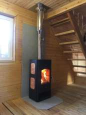 Популярный камин с дровницей Сибирь 8 в интерьере фото в Орше